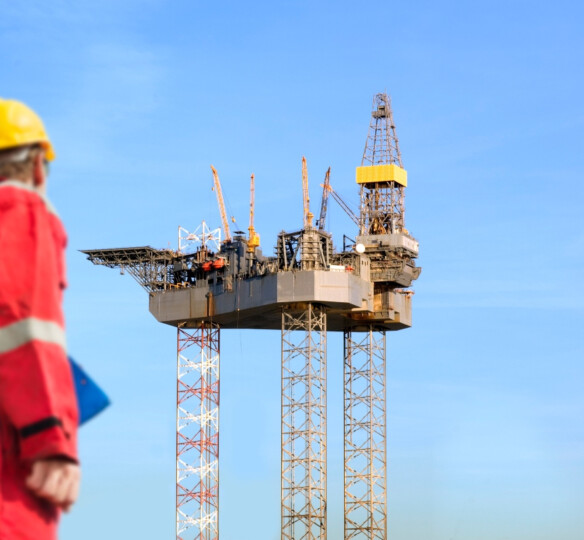 Oil & gas worker looking at rig