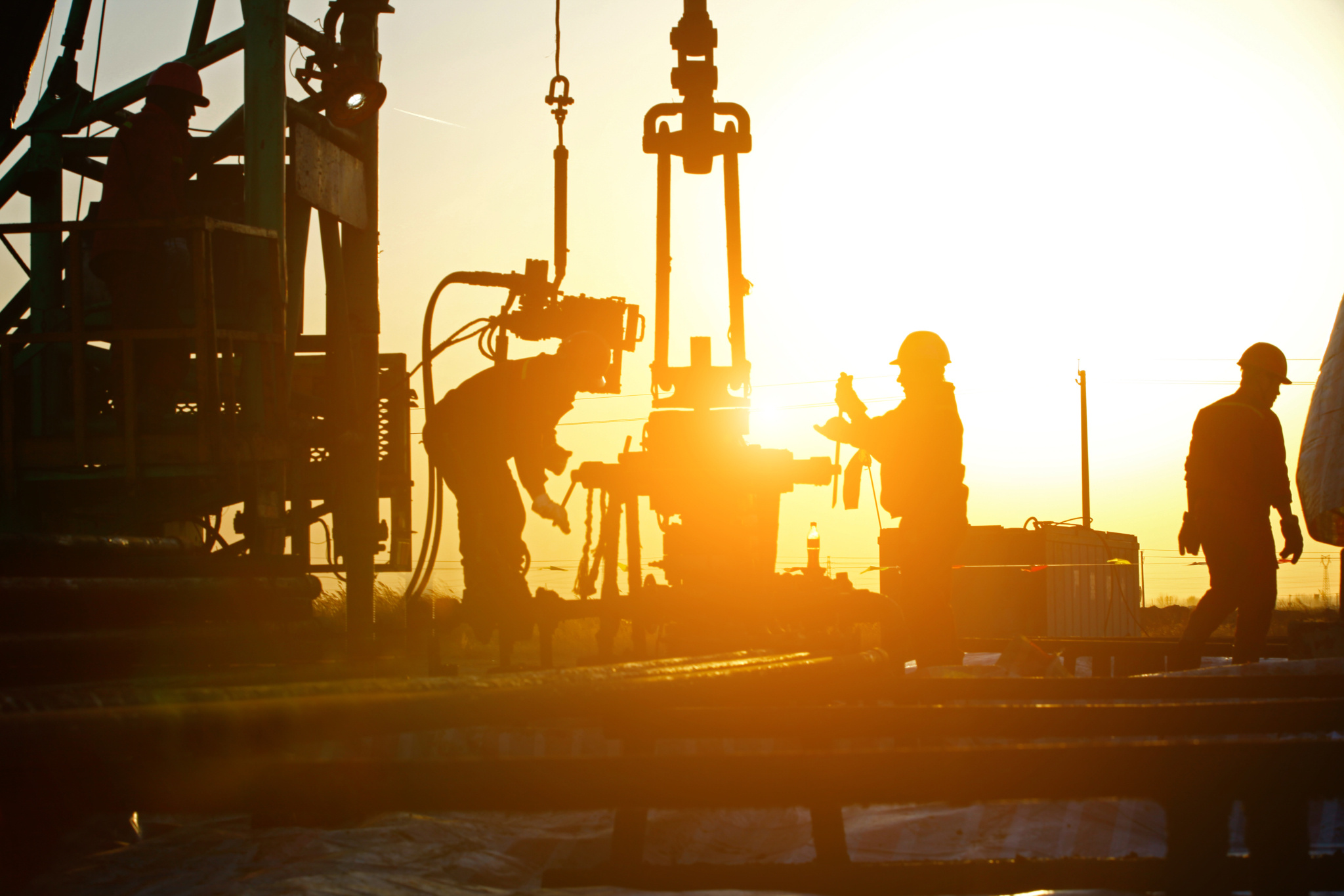 Image of offshore workers at sunset