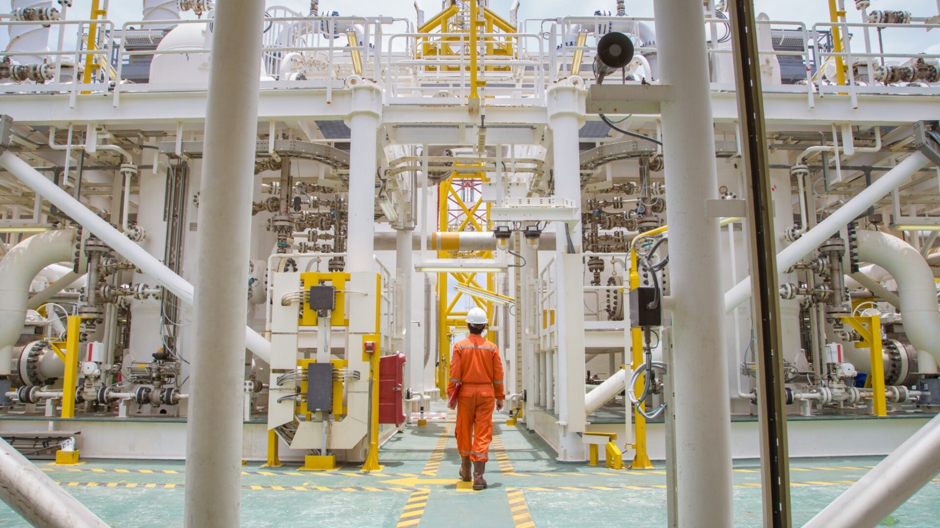 Oil rig worker walking on platform